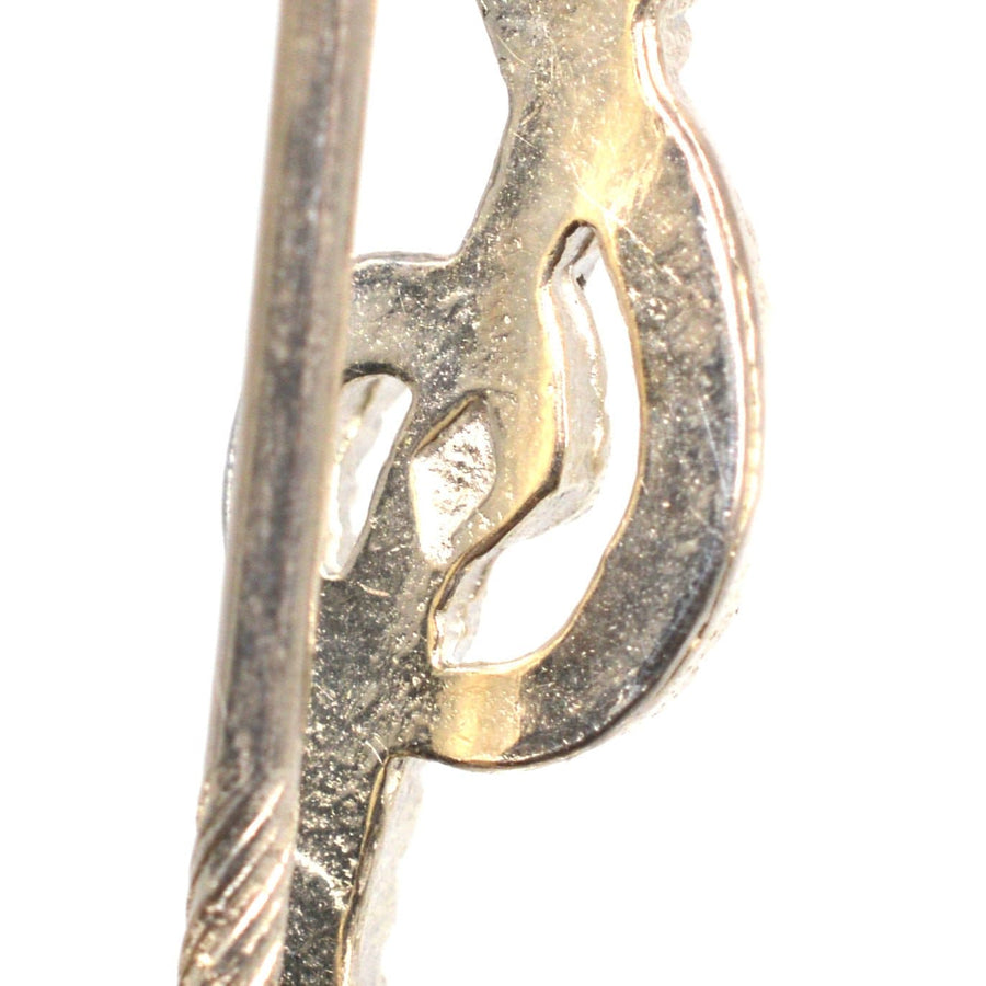 Vintage silver treble clef tie pin showcasing intricate rope detail, perfect for music lovers.