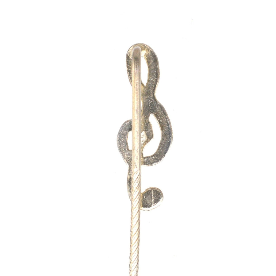 Vintage silver treble clef tie pin with rope detail, perfect for music lovers and adding flair to formal attire.