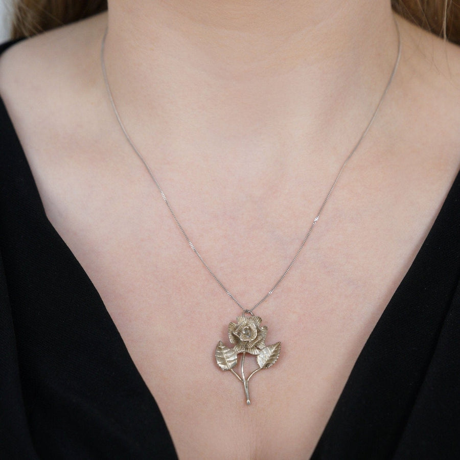 Vintage silver single rose pendant necklace, made in the 1970s, featuring rose leaves, perfect for romantic gifts.