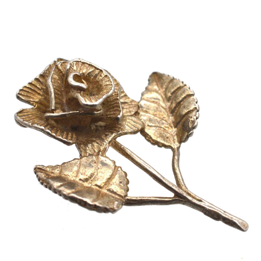 Vintage silver pendant featuring a single rose and leaves, crafted in the 1970s, perfect romantic gift.