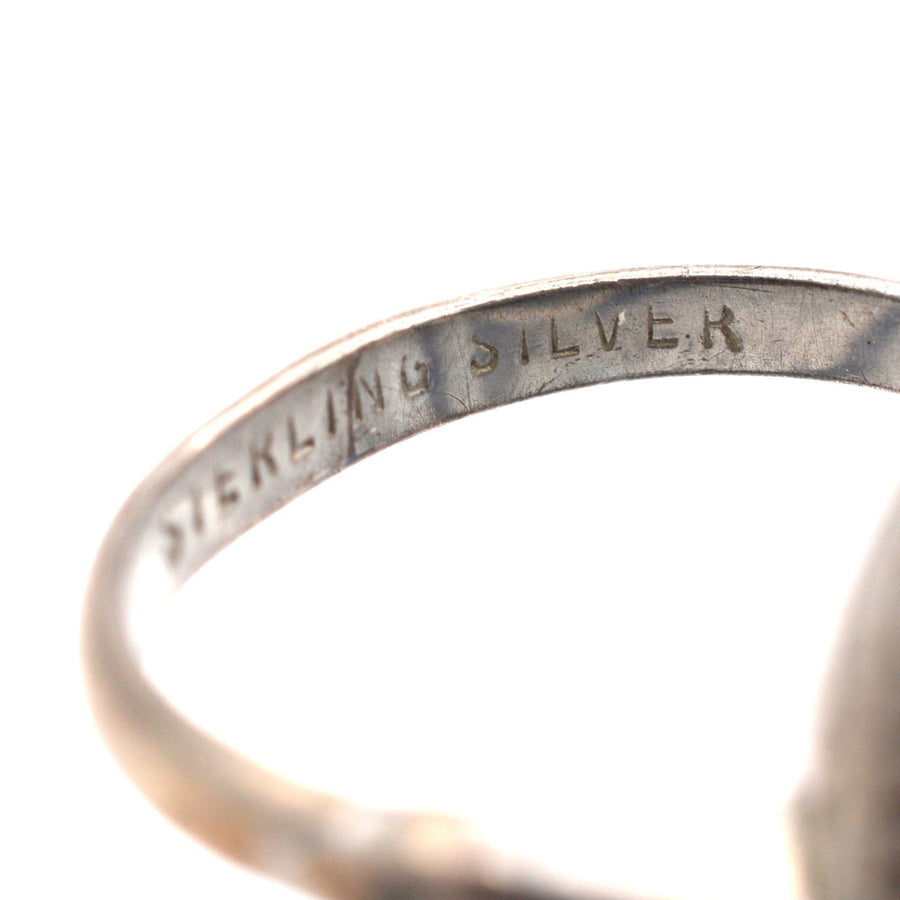 Close-up of the inner band of a vintage silver ring, showing the 'Sterling Silver' engraving.