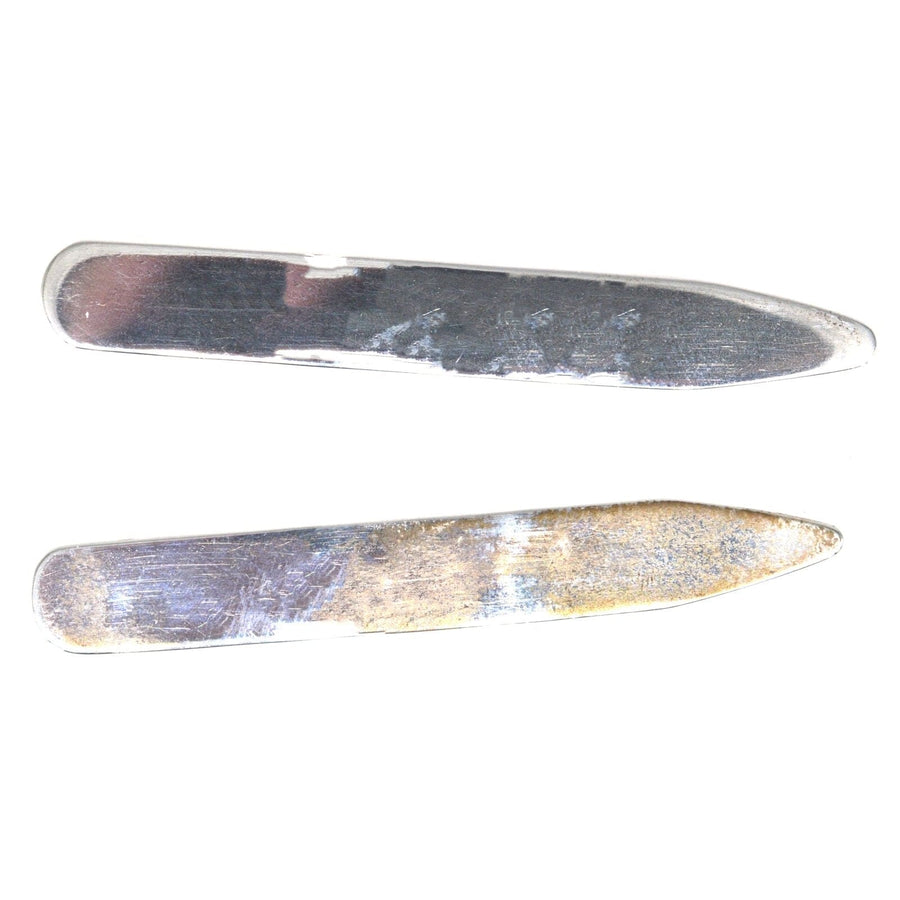 Vintage sterling silver shirt collar stiffeners, crafted in London, providing structure for a polished look.