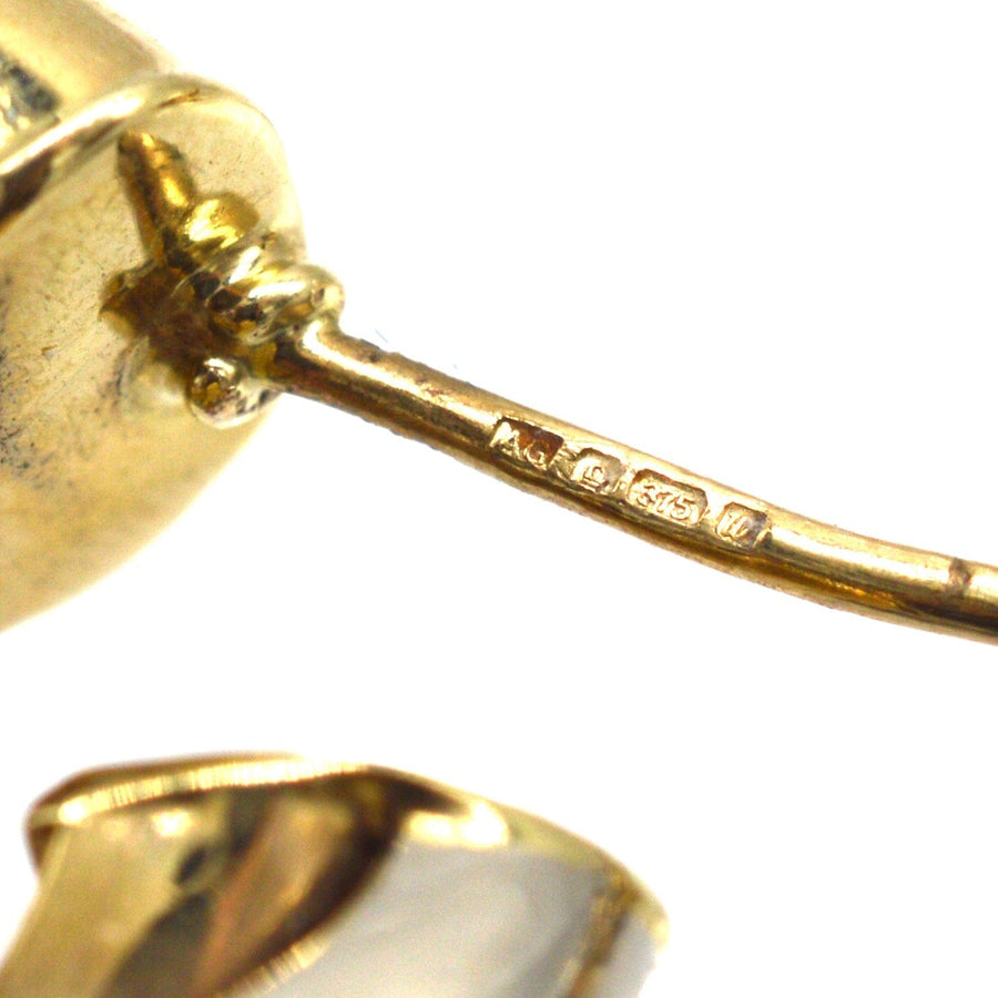 Close-up of the hallmark and craftsmanship of vintage three color gold earrings, showcasing quality and authenticity.
