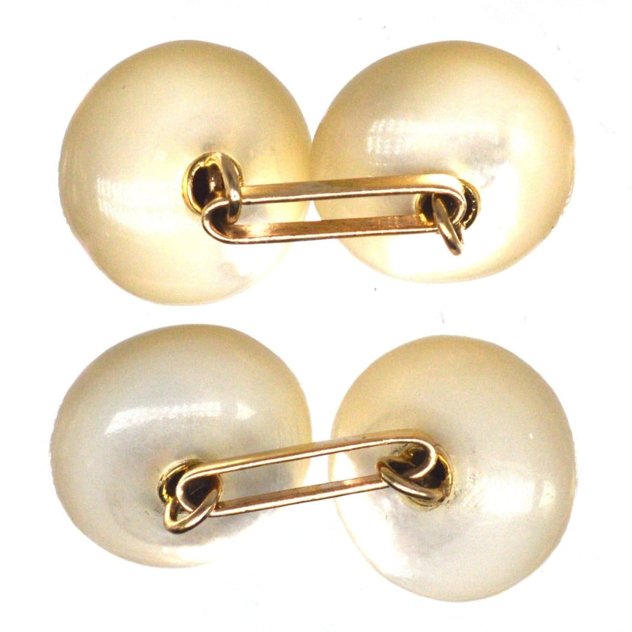 Vintage cufflinks featuring oval mother of pearl with a gold fastening, exuding elegance and sophistication.