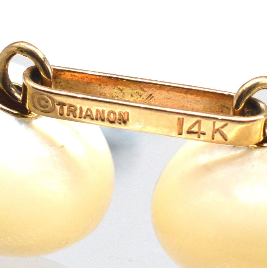 Close-up of Vintage Trianon 14ct gold cufflink showing mother of pearl detail and 14K marking.